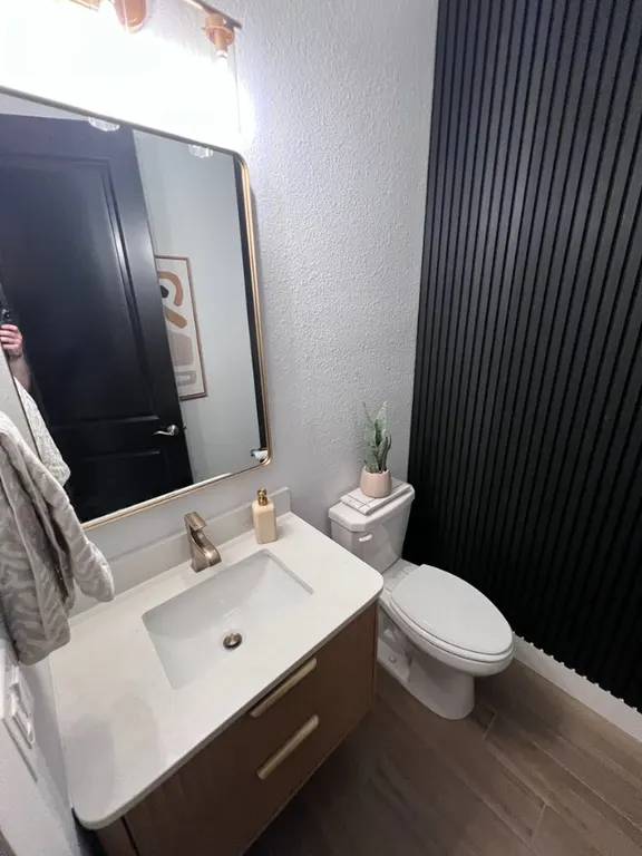 Bathroom update with floating vanity, mirror, fluted accent wall, and trim in Jacksonville, FL