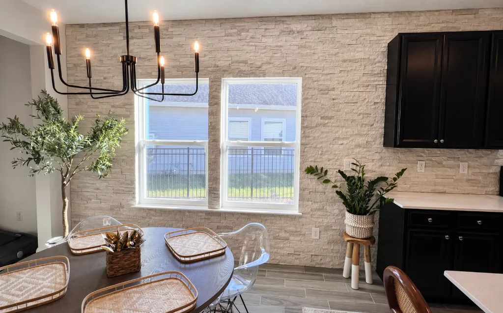 Polished stone ledger backsplash with dining area and cabinetry in Jacksonville, FL